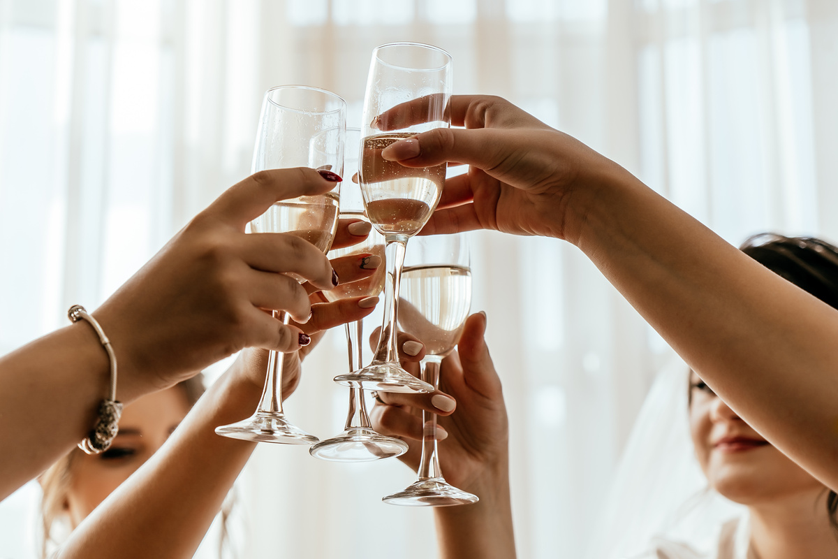 Bridesmaids hold glasses of champagne